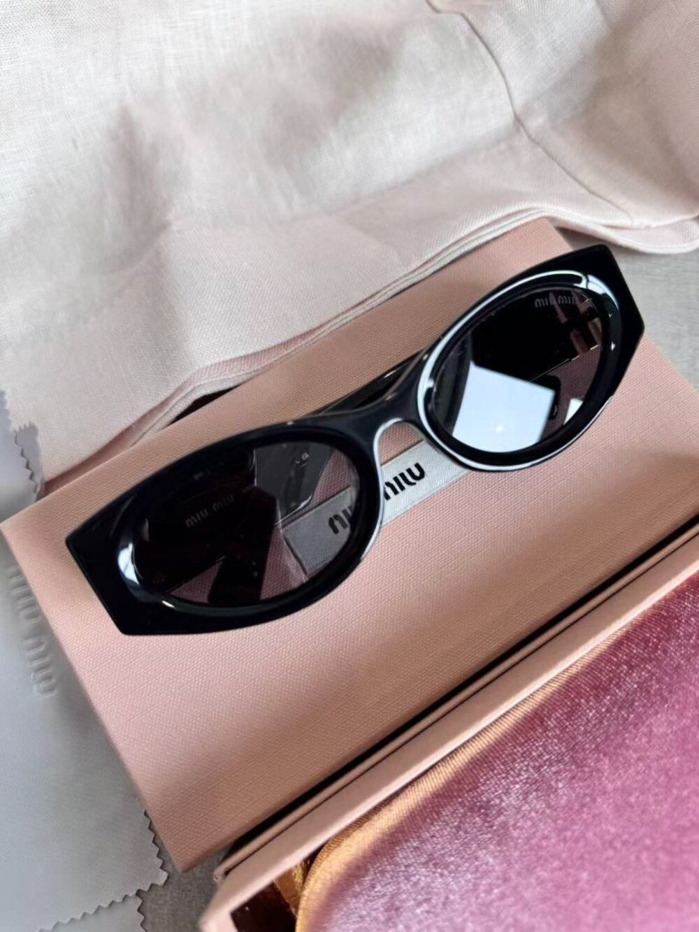 Miu Miu SMU 11W Oval Black Sunglasses with Gold Logo